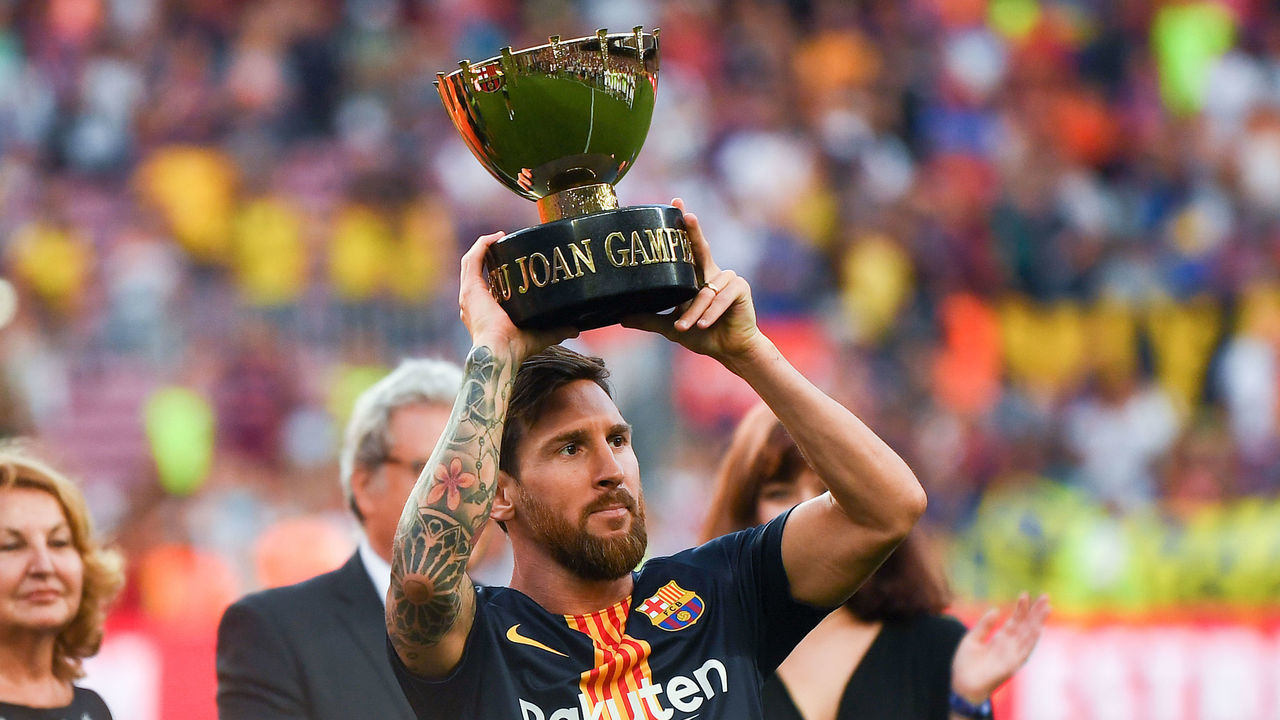 BARCELONA, SPAIN - AUGUST 15: Lionel Messi of FC Barcelona celebrates with the trophy after winning the Joan Gamper Trophy match between FC Barcelona and Boca Juniors at Camp Nou on August 15, 2018 in Barcelona, Spain.
