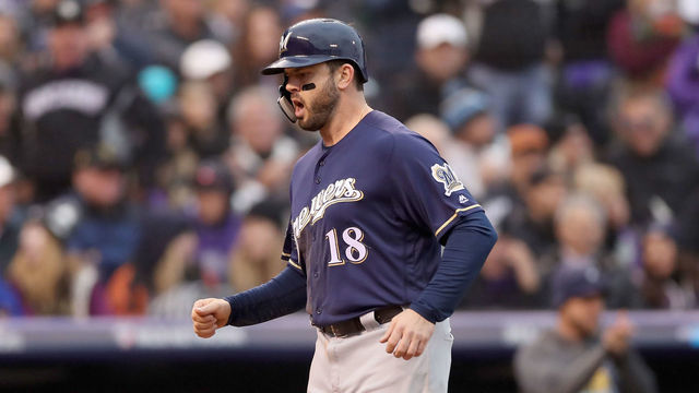 DENVER, CO - OCTOBER 07: Mike Moustakas #18 of the Milwaukee Brewers on a balk by the pitcher Scott Oberg #45 of the Colorado Rockies in the sixth inning of Game Three of the National League Division Series at Coors Field on October 7, 2018 in Denver, Colorado.