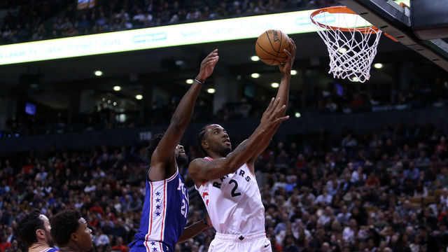 TORONTO, ON - OCTOBER 30: Kawhi Leonard #2 of the Toronto Raptors shoots the ball as Joel Embiid #21 of the Philadelphia 76ers defends during the second half of an NBA game at Scotiabank Arena on October 30, 2018 in Toronto, Canada.