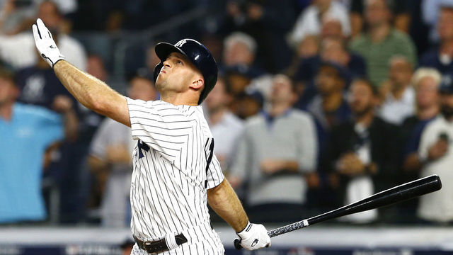 NEW YORK, NEW YORK - OCTOBER 09: Brett Gardner #11 of the New York Yankees hits a sac fly to score Gary Sanchez #24 against Rick Porcello #22 of the Boston Red Sox during the fifth inning in Game Four of the American League Division Series at Yankee Stadium on October 09, 2018 in the Bronx borough of New York City.