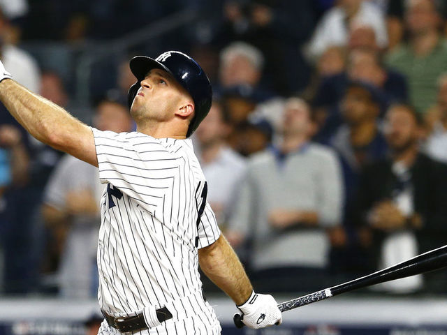 NEW YORK, NEW YORK - OCTOBER 09: Brett Gardner #11 of the New York Yankees hits a sac fly to score Gary Sanchez #24 against Rick Porcello #22 of the Boston Red Sox during the fifth inning in Game Four of the American League Division Series at Yankee Stadium on October 09, 2018 in the Bronx borough of New York City.
