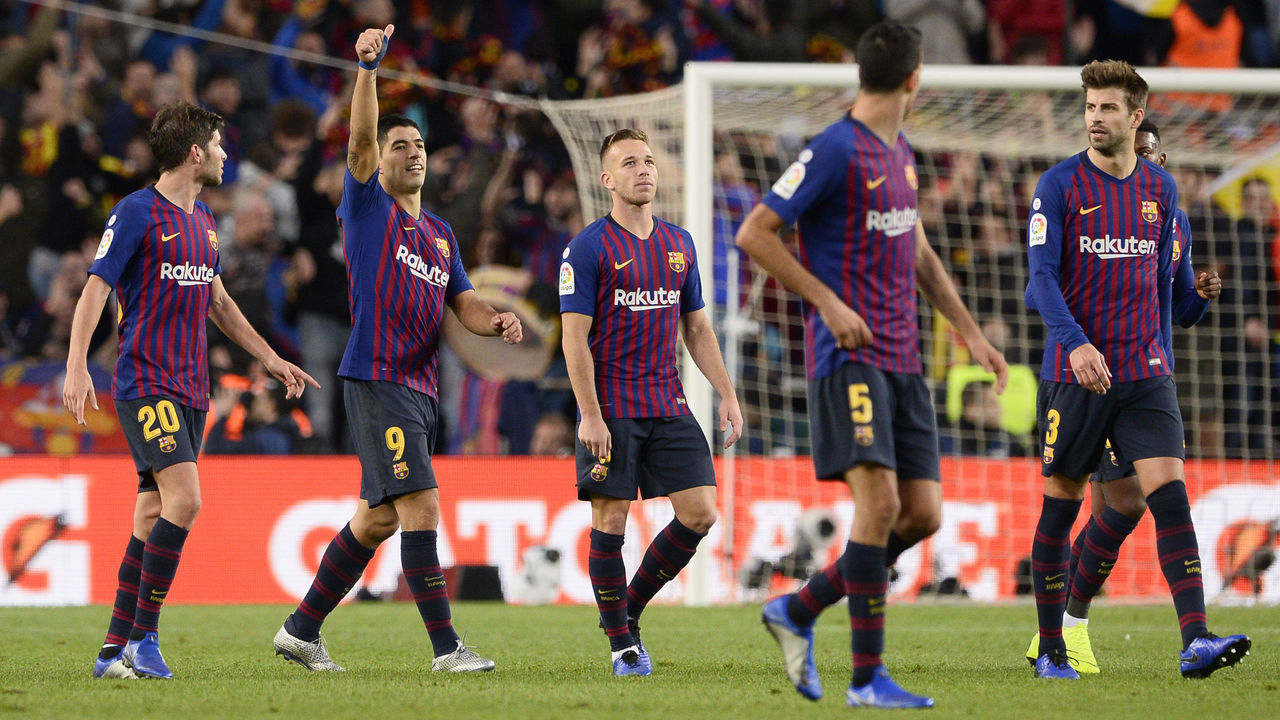 Barcelona's Uruguayan forward Luis Suarez (2L) celebrates his third goal with teammates during the Spanish league football match between FC Barcelona and Real Madrid CF at the Camp Nou stadium in Barcelona on October 28, 2018.