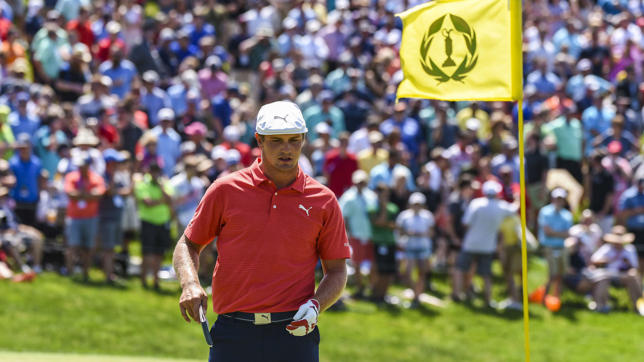 DUBLIN, OH - JUNE 03: Bryson DeChambeau reads the green as a tournament pin flag flies on the 18th hole green during a playoff in the final round of the Memorial Tournament presented by Nationwide at Muirfield Village Golf Club on June 3, 2018 in Dublin, Ohio.