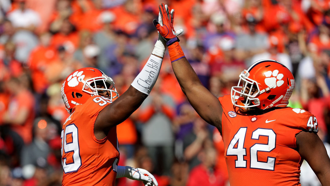 CLEMSON, SC - NOVEMBER 03: Teamamtes James Edwards #95 and Christian Wilkins #42 of the Clemson Tigers react after a defensive play against the Louisville Cardinals during their game at Clemson Memorial Stadium on November 3, 2018 in Clemson, South Carolina.