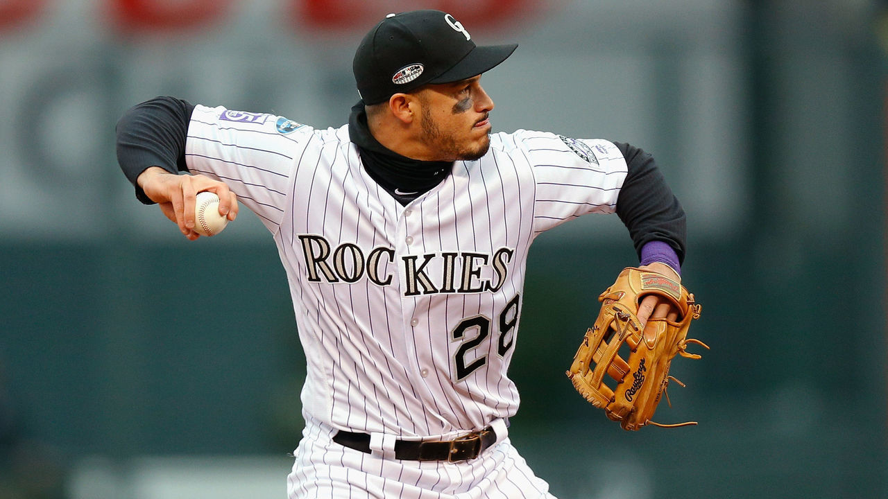 DENVER, CO - OCTOBER 07: Nolan Arenado #28 of the Colorado Rockies throws out Travis Shaw #21 of the Milwaukee Brewers in the fourth inning of Game Three of the National League Division Series against the Milwaukee Brewers at Coors Field on October 7, 2018 in Denver, Colorado.