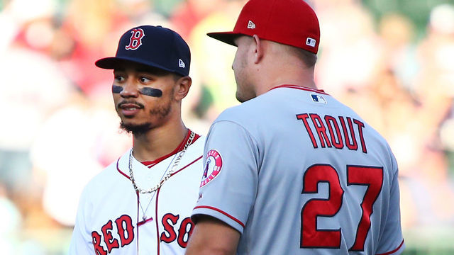 BOSTON, MA - JUNE 26: Mike Trout #27 of the Los Angeles Angels talks to Mookie Betts #50 of the Boston Red Sox before a game against the Boston Red Sox at Fenway Park on June 26, 2018 in Boston, Massachusetts.