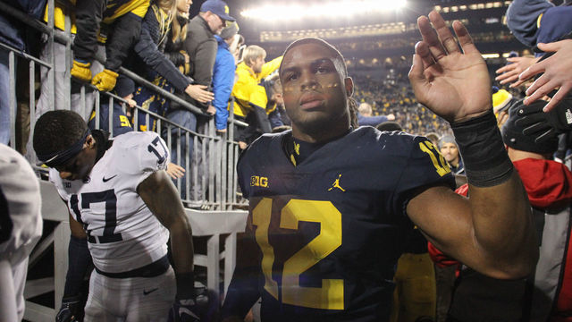 ANN ARBOR, MI - NOVEMBER 03: Michigan Wolverines linebacker Josh Ross (12) slaps hands with fans as he walks off of the field at the conclusion of a game between the Penn State Nittany Lions (14) and the Michigan Wolverines (5) on November 3, 2018 at Michigan Stadium in Ann Arbor, Michigan.