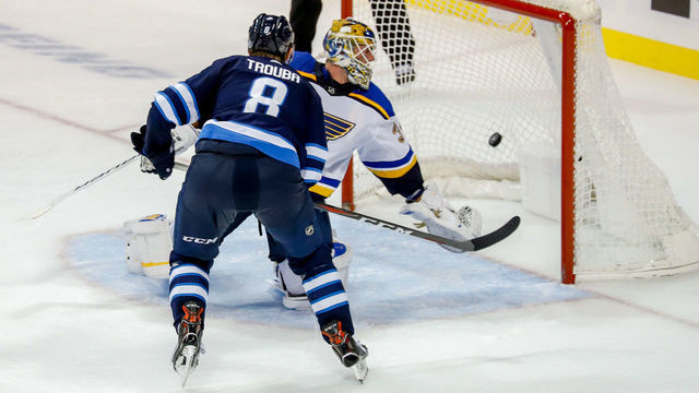 WINNIPEG, MB - OCTOBER 22: Jacob Trouba #8 of the Winnipeg Jets shoots the puck past goaltender Jake Allen #34 of the St. Louis Blues for the overtime winner at the Bell MTS Place on October 22, 2018 in Winnipeg, Manitoba, Canada. The Jets defeated the Blues 5-4.