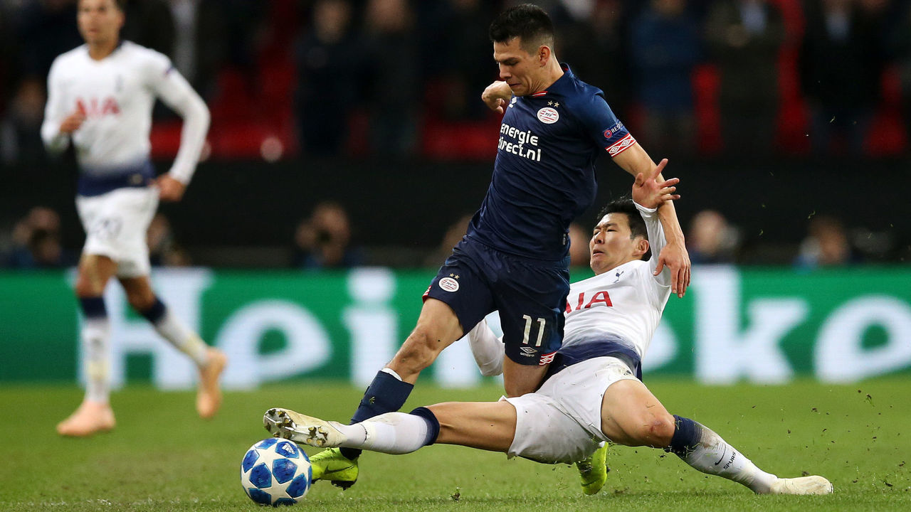 LONDON, ENGLAND - NOVEMBER 06: Hirving Lozano of PSV Eindhoven is tackled by Heung-Min Son of Tottenham Hotspur during the Group B match of the UEFA Champions League between Tottenham Hotspur and PSV at Wembley Stadium on November 6, 2018 in London, United Kingdom.