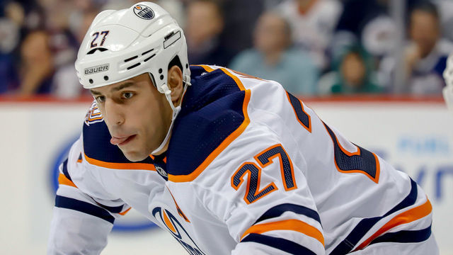 WINNIPEG, MB - OCTOBER 16: Milan Lucic #27 of the Edmonton Oilers gets set during a first period face-off against the Winnipeg Jets at the Bell MTS Place on October 16, 2018 in Winnipeg, Manitoba, Canada.