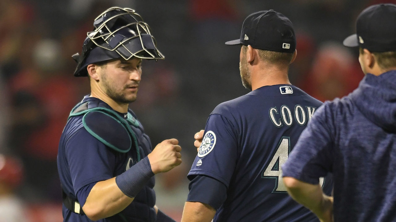 ANAHEIM, CA - SEPTEMBER 14: Mike Zunino #3 of the Seattle Mariners congratulates Ryan Cook #46 after a 5-0 victory over the Los Angeles Angels of Anaheim at Angel Stadium on September 14, 2018 in Anaheim, California.