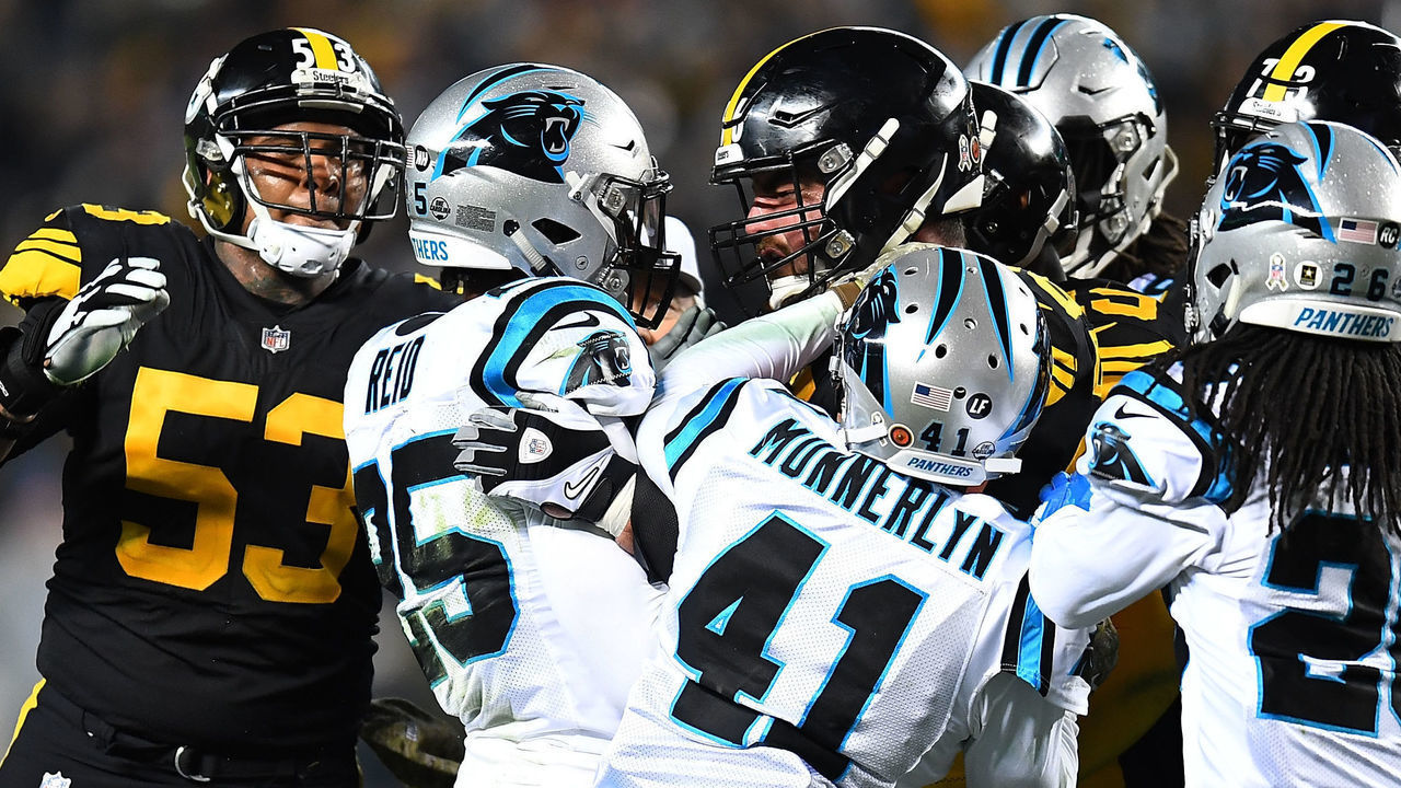 PITTSBURGH, PA - NOVEMBER 08: David DeCastro #66 of the Pittsburgh Steelers shoves Eric Reid #25 of the Carolina Panthers after a late hit on Ben Roethlisberger #7 during the third quarter in the game at Heinz Field on November 8, 2018 in Pittsburgh, Pennsylvania.
