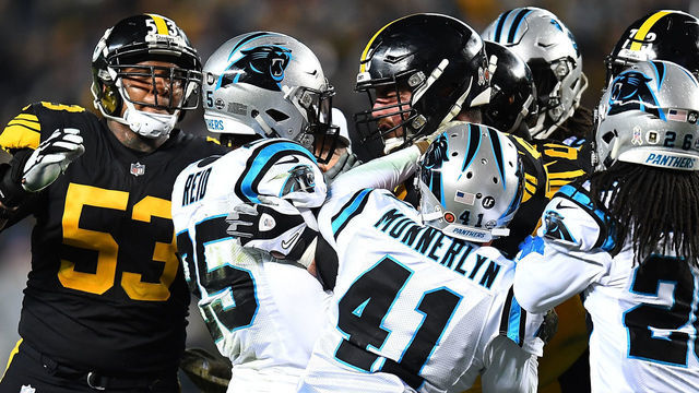PITTSBURGH, PA - NOVEMBER 08: David DeCastro #66 of the Pittsburgh Steelers shoves Eric Reid #25 of the Carolina Panthers after a late hit on Ben Roethlisberger #7 during the third quarter in the game at Heinz Field on November 8, 2018 in Pittsburgh, Pennsylvania.