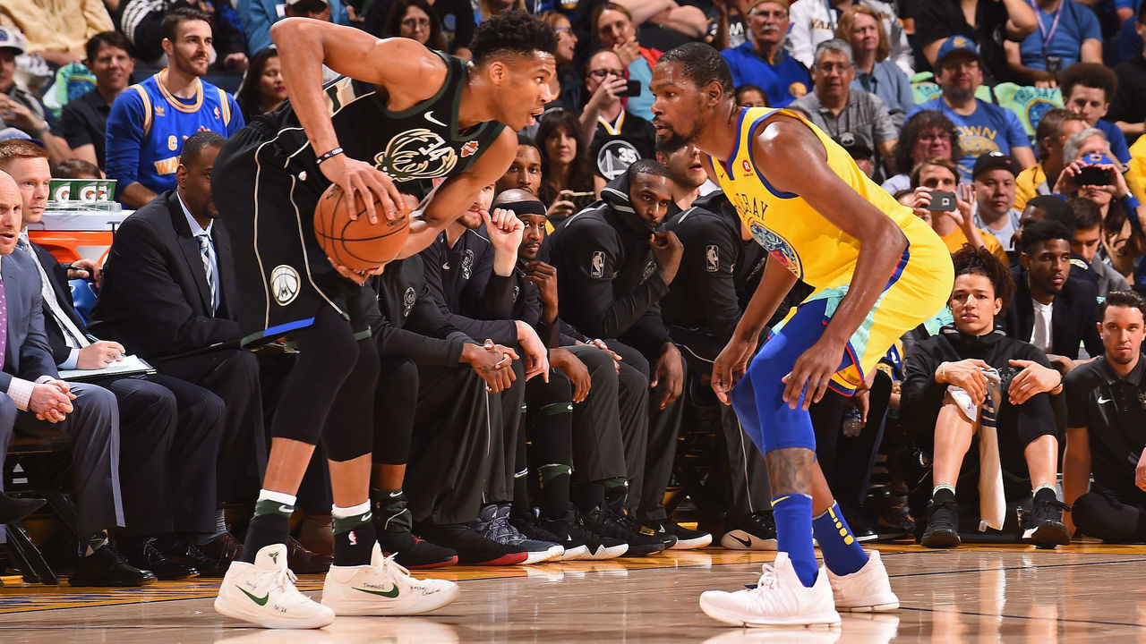 OAKLAND, CA - MARCH 29: Giannis Antetokounmpo #34 of the Milwaukee Bucks handles the ball against Kevin Durant #35 of the Golden State Warriors on March 29, 2018 at ORACLE Arena in Oakland, California. NOTE TO USER: User expressly acknowledges and agrees that, by downloading and/or using this photograph, user is consenting to the terms and conditions of Getty Images License Agreement. Mandatory Copyright Notice: Copyright 2018 NBAE