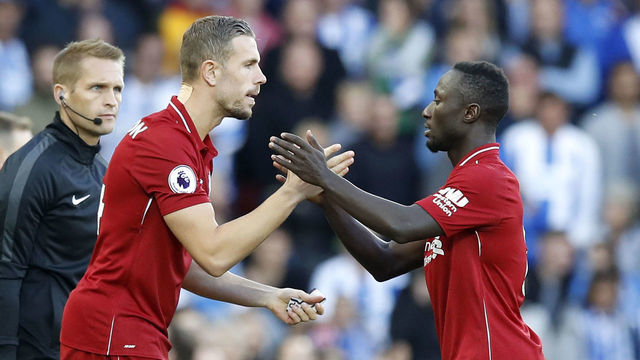 Liverpool's Jordan Henderson (left) is substituted on for Naby Keita during the Premier League match at Anfield, Liverpool.