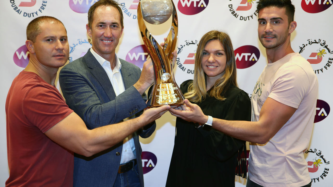 SINGAPORE - OCTOBER 20: Simona Halep of Romania poses with her coach Darren Cahill and team after winning the Chris Evert WTA World No.1 trophyÊfor her achievement of securing theÊWTA Year End World No.1 Ranking presented by Dubai Duty Free. She is the first player to receive the newly named trophy.
