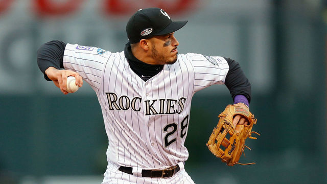 DENVER, CO - OCTOBER 07: Nolan Arenado #28 of the Colorado Rockies throws out Travis Shaw #21 of the Milwaukee Brewers in the fourth inning of Game Three of the National League Division Series against the Milwaukee Brewers at Coors Field on October 7, 2018 in Denver, Colorado.