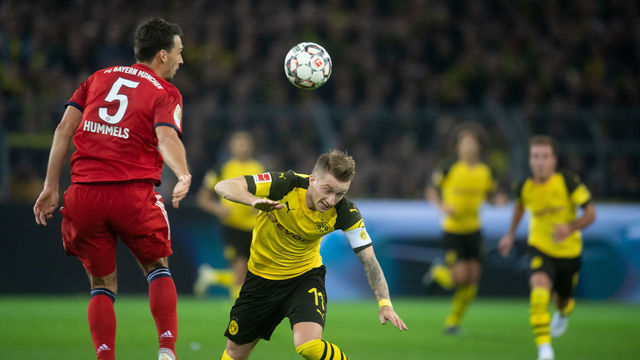 10 November 2018, North Rhine-Westphalia, Dortmund: Soccer: Bundesliga, Borussia Dortmund - Bayern Munich, 11th matchday at Signal Iduna Park. Dortmund's Marco Reus (r) and Mats Hummels of Bavaria are trying to get the ball. Photo: Bernd Thissen/dpa - IMPORTANT NOTE: In accordance with the requirements of the DFL Deutsche Fußball Liga or the DFB Deutscher Fußball-Bund, it is prohibited to use or have used photographs taken in the stadium and/or the match in the form of sequence images and/or video-like photo sequences.