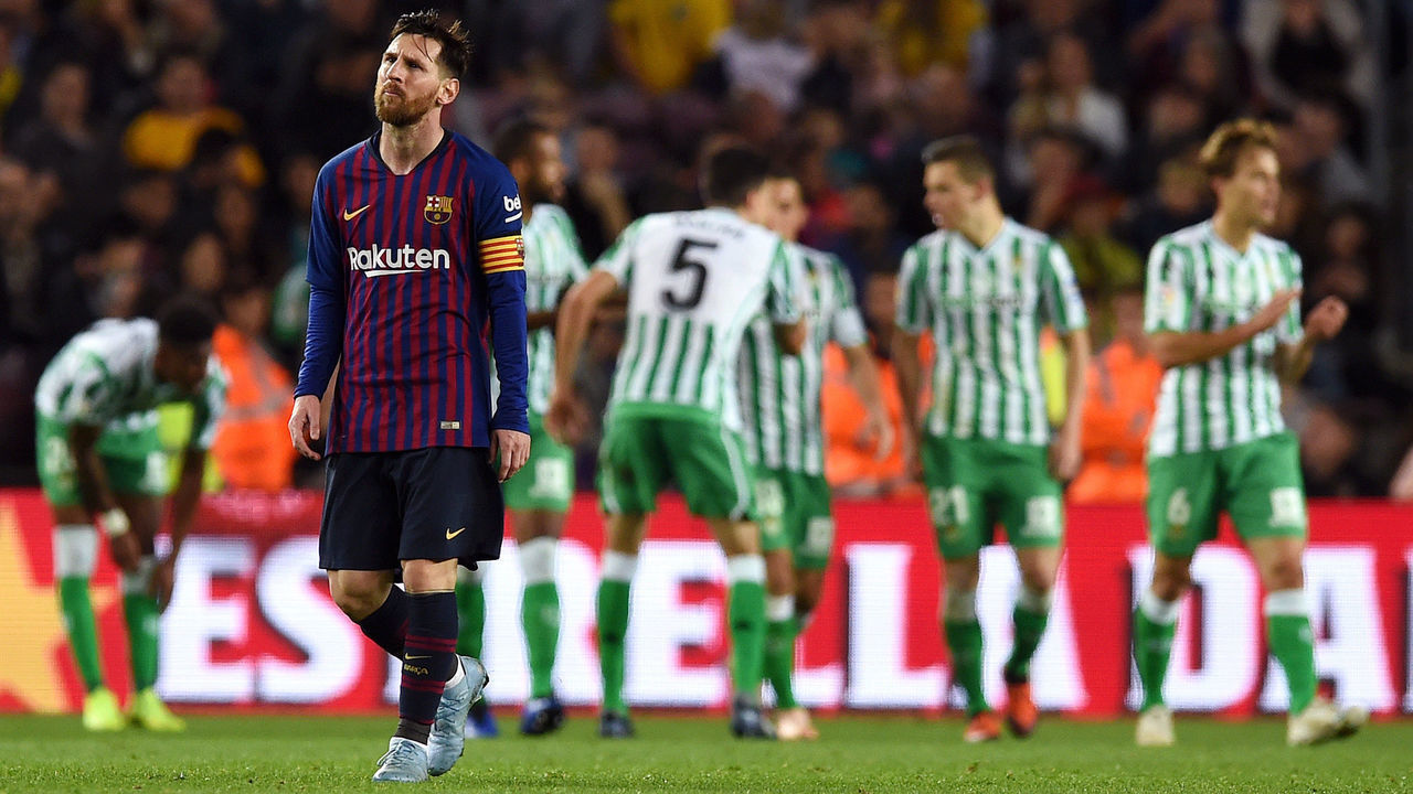 BARCELONA, SPAIN - NOVEMBER 11: Lionel Messi of Barcelona looks dejected as the Real Betis players celebrate their sides fourth goal during the La Liga match between FC Barcelona and Real Betis Balompie at Camp Nou on November 11, 2018 in Barcelona, Spain.