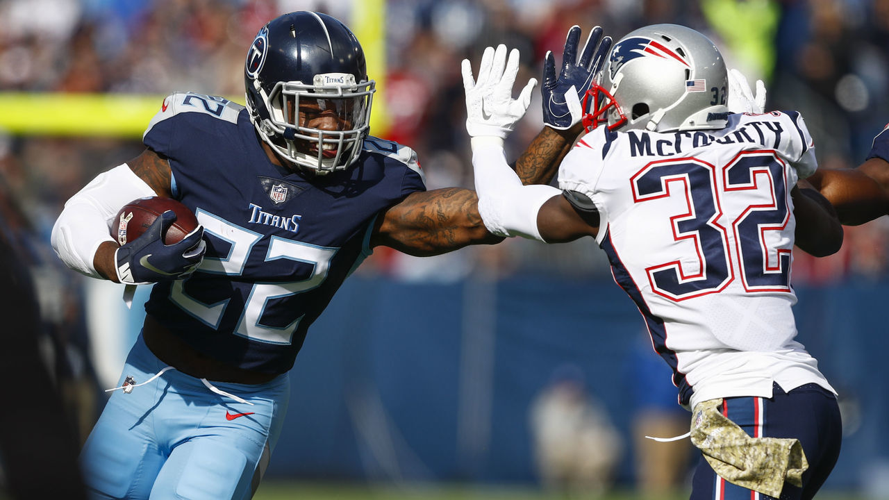 NASHVILLE, TN - NOVEMBER 11: Derrick Henry #22 of the Tennessee Titans blocks Devin McCourty #32 of the New England Patriots while running with the ball during the first quarter at Nissan Stadium on November 11, 2018 in Nashville, Tennessee.