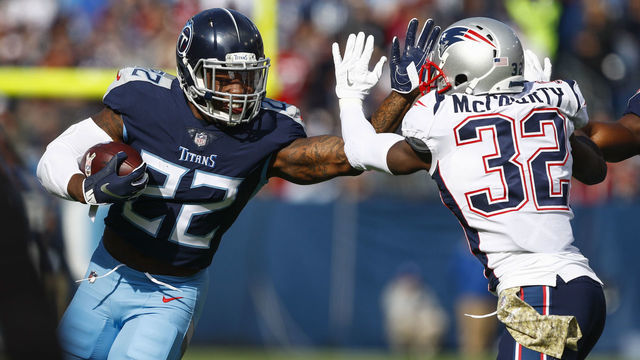 NASHVILLE, TN - NOVEMBER 11: Derrick Henry #22 of the Tennessee Titans blocks Devin McCourty #32 of the New England Patriots while running with the ball during the first quarter at Nissan Stadium on November 11, 2018 in Nashville, Tennessee.