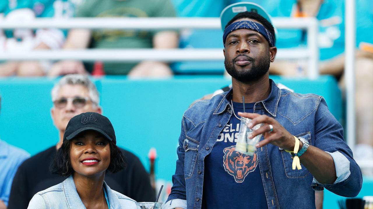 MIAMI, FL - OCTOBER 14: Dwyane Wade of the Miami Heat and wife and actress Gabrielle Union attend the game between the Miami Dolphins and Chicago Bears at Hard Rock Stadium on October 14, 2018 in Miami, Florida.