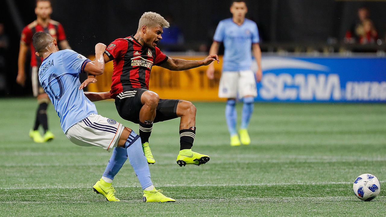 ATLANTA, GA - NOVEMBER 11: Josef Martinez #7 of Atlanta United and Yangel Herrera #30 of New York City react after a collision during the Eastern Conference Semifinals between New York City FC and Atlanta United FC at Mercedes-Benz Stadium on November 11, 2018 in Atlanta, Georgia.