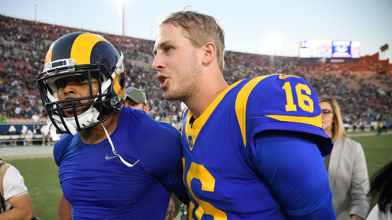 LOS ANGELES, CA - NOVEMBER 11: Quarterback Jared Goff #16 and defensive end Aaron Donald #99 of the Los Angeles Rams walk off the field after winning 36-31 against the Seattle Seahawks at Los Angeles Memorial Coliseum on November 11, 2018 in Los Angeles, California.