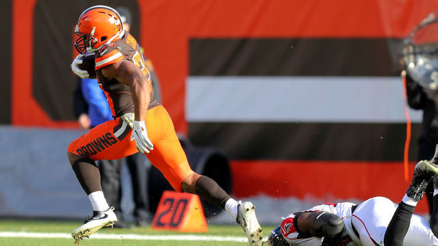 CLEVELAND, OH - NOVEMBER 11: Cleveland Browns running back Nick Chubb (24) runs out of the tackle attempt of Atlanta Falcons linebacker Foye Oluokun (54) as he races 92-yards for a touchdown during the third quarter of the National Football League game between the Atlanta Falcons and Cleveland Browns on November 11, 2018, at FirstEnergy Stadium in Cleveland, OH.