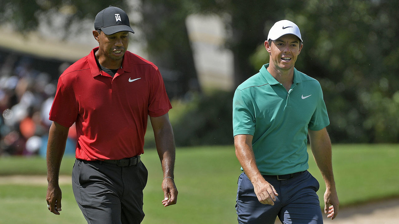 ATLANTA, GA - SEPTEMBER 23: Tiger Woods and Rory McIlroy of Northern Ireland walk down the fairway of the first hole during the final round of the TOUR Championship at East Lake Golf Club on September 23, 2018, in Atlanta, Georgia.