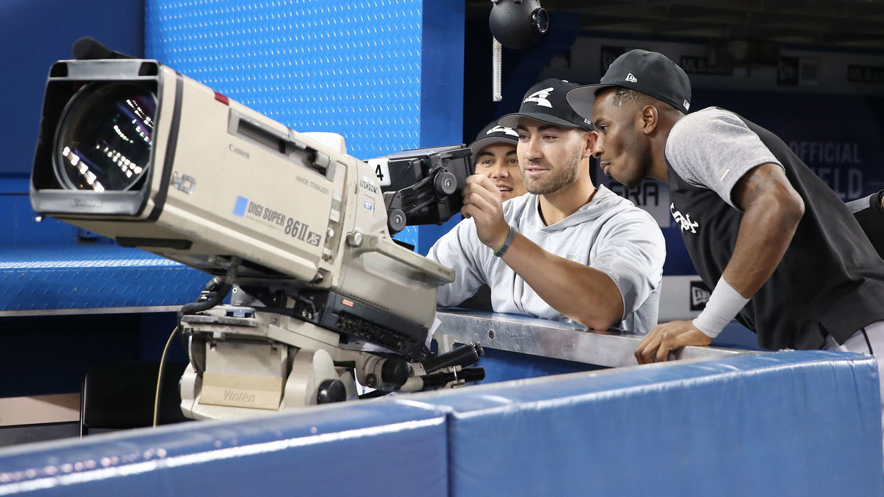 TORONTO, ON - APRIL 4: Tyler Saladino #20 of the Chicago White Sox and Nicky Delmonico #30 and Tim Anderson #7 look through a viewfinder as they play with a television camera during batting practice before the start of MLB game action against the Toronto Blue Jays at Rogers Centre on April 4, 2018 in Toronto, Canada. *** Local Caption *** Tyler Saladino;Nicky Delmonico;Tim Anderson