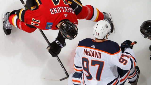 CALGARY, AB - MARCH 13: Connor McDavid #97 of the Edmonton Oilers faces off against Mikael Backlund #11 of the Calgary Flames at Scotiabank Saddledome on March 13, 2018 in Calgary, Alberta, Canada. *** Local Caption *** Connor McDavid;Mikael Backlund