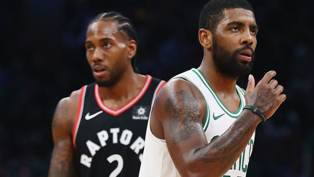 BOSTON, MA - NOVEMBER 16: Kawhi Leonard #2 of the Toronto Raptors and Kyrie Irving #11 of the Boston Celtics look on during the first half at TD Garden on November 16, 2018 in Boston, Massachusetts.