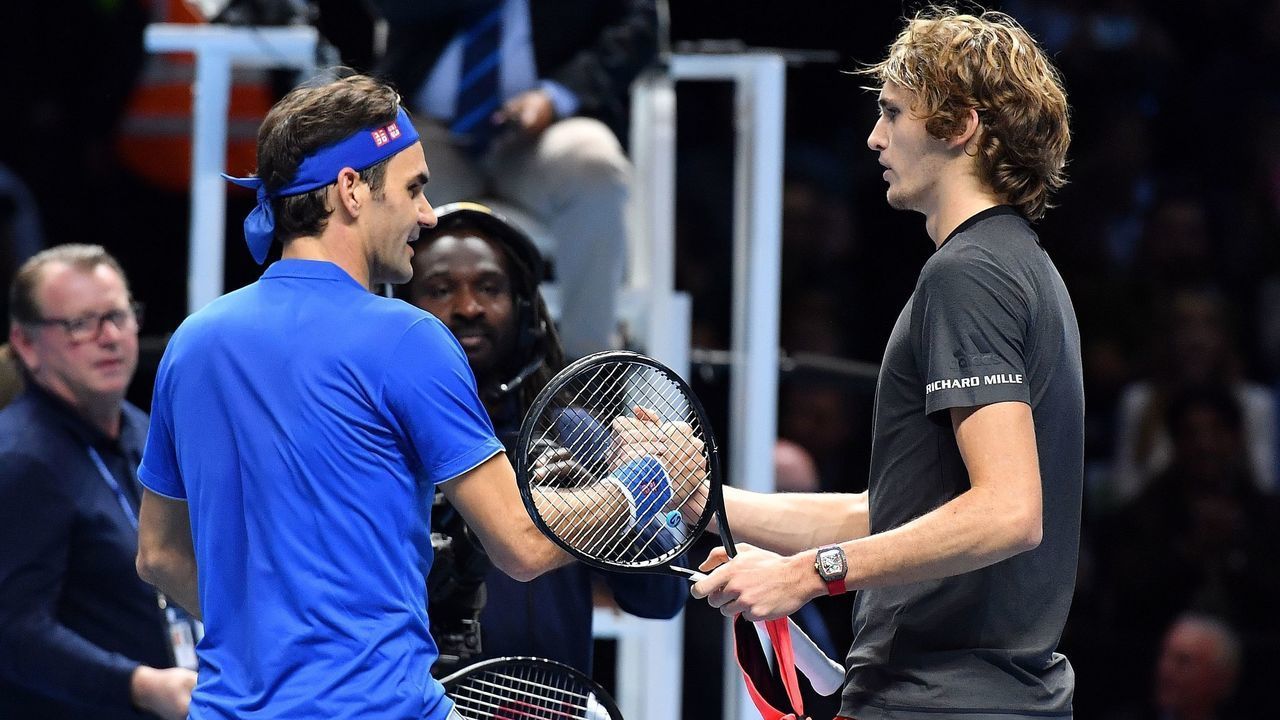 Germany's Alexander Zverev (R) shakes hands after winning against against Switzerland's Roger Federer during their men's singles semi-final match on day seven of the ATP World Tour Finals tennis tournament at the O2 Arena in London on November 17, 2018.