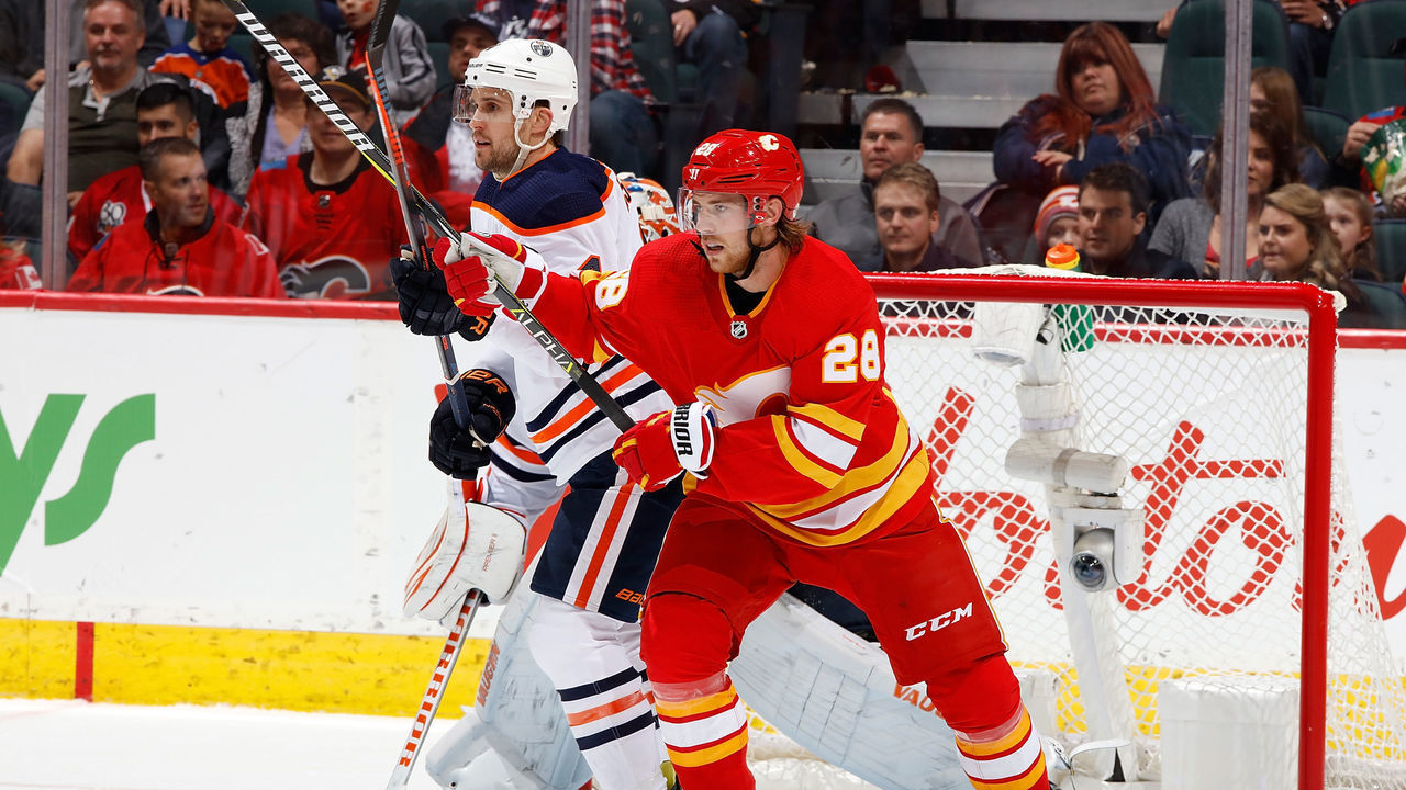 CALGARY, AB - NOVEMBER 17: Elias Lindholm #28 of the Calgary Flames skates against Kris Russell #4 of the Edmonton Oilers during an NHL game on November 17, 2018 at the Scotiabank Saddledome in Calgary, Alberta, Canada.