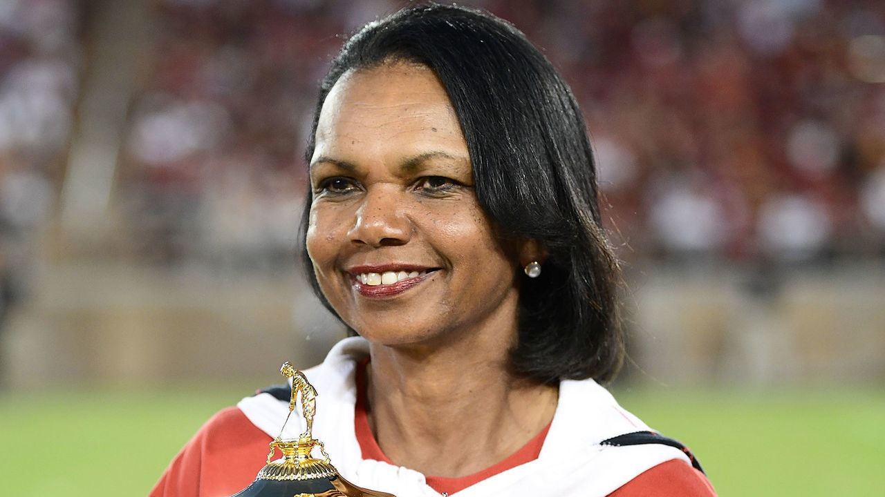 PALO ALTO, CA - SEPTEMBER 08: Condoleezza Rice with the Ryder Cup Trophy on the field during a time out of the third quarter of an NCAA football game between the USC Trojans and Stanford Cardinal at Stanford Stadium on September 8, 2018 in Palo Alto, California.