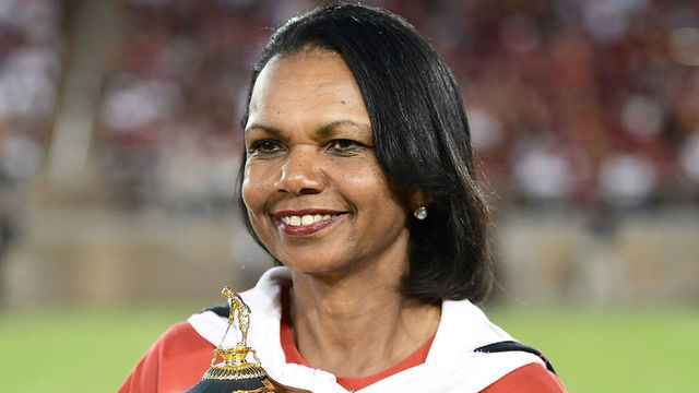 PALO ALTO, CA - SEPTEMBER 08: Condoleezza Rice with the Ryder Cup Trophy on the field during a time out of the third quarter of an NCAA football game between the USC Trojans and Stanford Cardinal at Stanford Stadium on September 8, 2018 in Palo Alto, California.