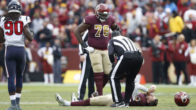 LANDOVER, MD - NOVEMBER 18: Alex Smith #11 of the Washington Redskins lays on the field after being sacked and injured by Kareem Jackson #25 of the Houston Texans in the third quarter of the game at FedExField on November 18, 2018 in Landover, Maryland.