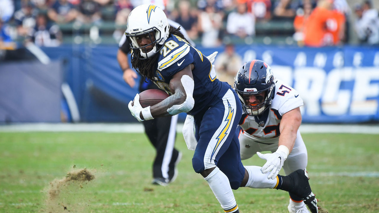CARSON, CA - NOVEMBER 18: Running back Melvin Gordon #28 of the Los Angeles Chargers runs in front of inside linebacker Joey Jewell #47 of the Denver Broncos in the third quarter at StubHub Center on November 18, 2018 in Carson, California.
