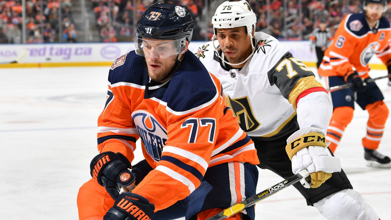 EDMONTON, AB - NOVEMBER 18: Oscar Klefbom #77 of the Edmonton Oilers battles for the puck against Ryan Reaves #75 of the Vegas Golden Knights on November 18, 2018 at Rogers Place in Edmonton, Alberta, Canada.