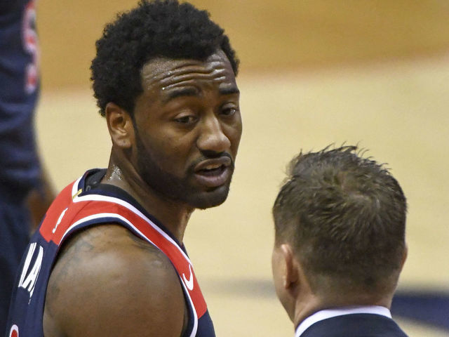 WASHINGTON, DC - APRIL 10: Washington Wizards guard John Wall (2) talks with Washington Wizards head coach Scott Brooks (R) during the game against the Boston Celtics on April 10, 2018 at the Capital One Arena in Washington, D.C.