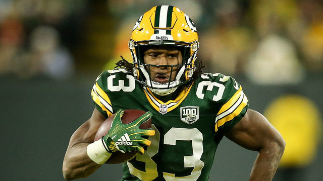 GREEN BAY, WISCONSIN - NOVEMBER 11: Aaron Jones #33 of the Green Bay Packers runs with the ball in the third quarter against the Miami Dolphins at Lambeau Field on November 11, 2018 in Green Bay, Wisconsin.