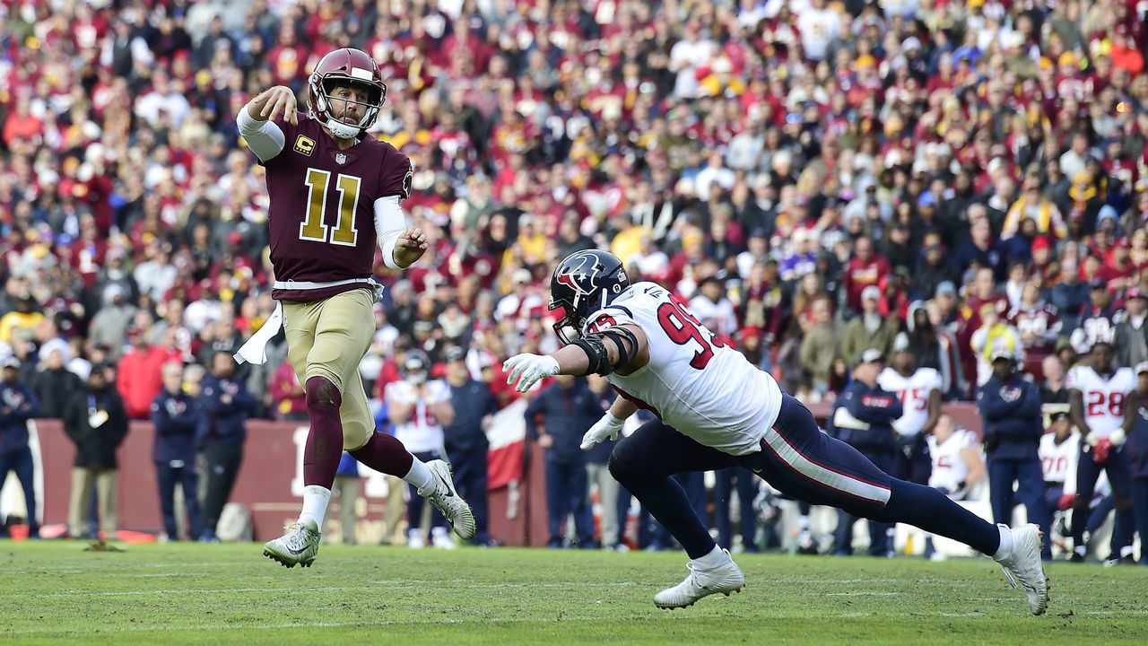 LANDOVER, MD - NOVEMBER 18: Alex Smith #11 of the Washington Redskins throws a pass as he is chased by J.J. Watt #99 of the Houston Texans in the first half at FedExField on November 18, 2018 in Landover, Maryland.