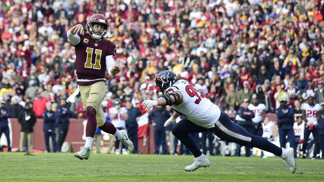 LANDOVER, MD - NOVEMBER 18: Alex Smith #11 of the Washington Redskins throws a pass as he is chased by J.J. Watt #99 of the Houston Texans in the first half at FedExField on November 18, 2018 in Landover, Maryland.