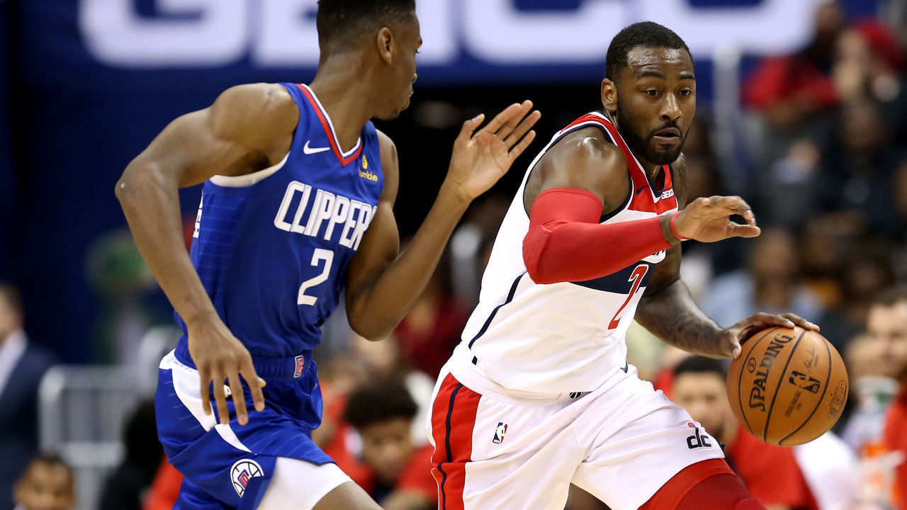 WASHINGTON, DC - NOVEMBER 20: John Wall #2 of the Washington Wizards dribbles past Shai Gilgeous-Alexander #2 of the LA Clippers during the second half at Capital One Arena on November 20, 2018 in Washington, DC.
