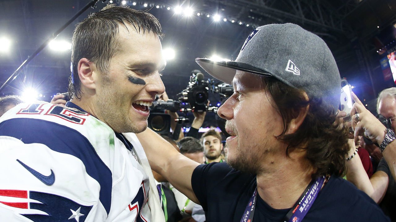 GLENDALE, AZ - FEBRUARY 01: Tom Brady #12 of the New England Patriots celebrates with Mark Wahlberg after defeating the Seattle Seahawks 28-24 to win Super Bowl XLIX at University of Phoenix Stadium on February 1, 2015 in Glendale, Arizona.