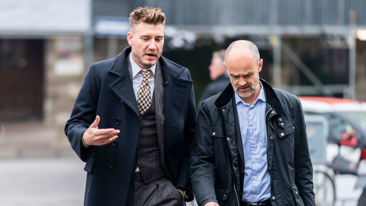 Rosenborg's Danish football player Nicklas Bendtner and lawyer Anders Nemeth arrive for a hearing at Copenhagen City Council on November 2, 2018. - Nicklas Bendtner has been charged with violence against a taxi driver in Copenhagen while the driver has been charged with attempted violence.
