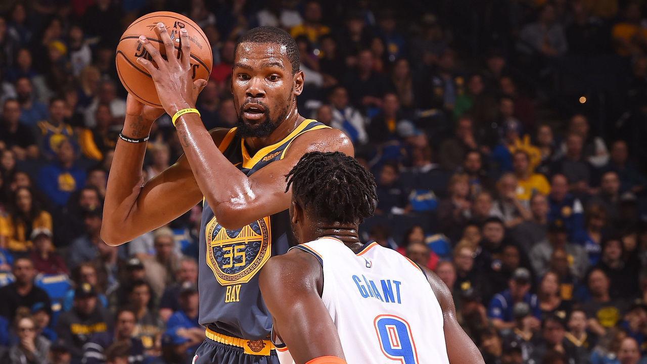 OAKLAND, CA - NOVEMBER 21: Kevin Durant #35 of the Golden State Warriors passes the ball during the game against Jerami Grant #9 of the Oklahoma City Thunder on November 21, 2018 at ORACLE Arena in Oakland, California. NOTE TO USER: User expressly acknowledges and agrees that, by downloading and or using this photograph, user is consenting to the terms and conditions of Getty Images License Agreement. Mandatory Copyright Notice: Copyright 2018 NBAE