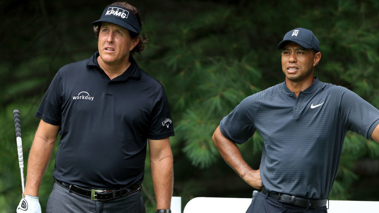 AKRON, OH - AUGUST 01: Phil Mickelson (L) and Tiger Woods meet during a preview day of the World Golf Championships - Bridgestone Invitational at Firestone Country Club South Course at on August 1, 2018 in Akron, Ohio.