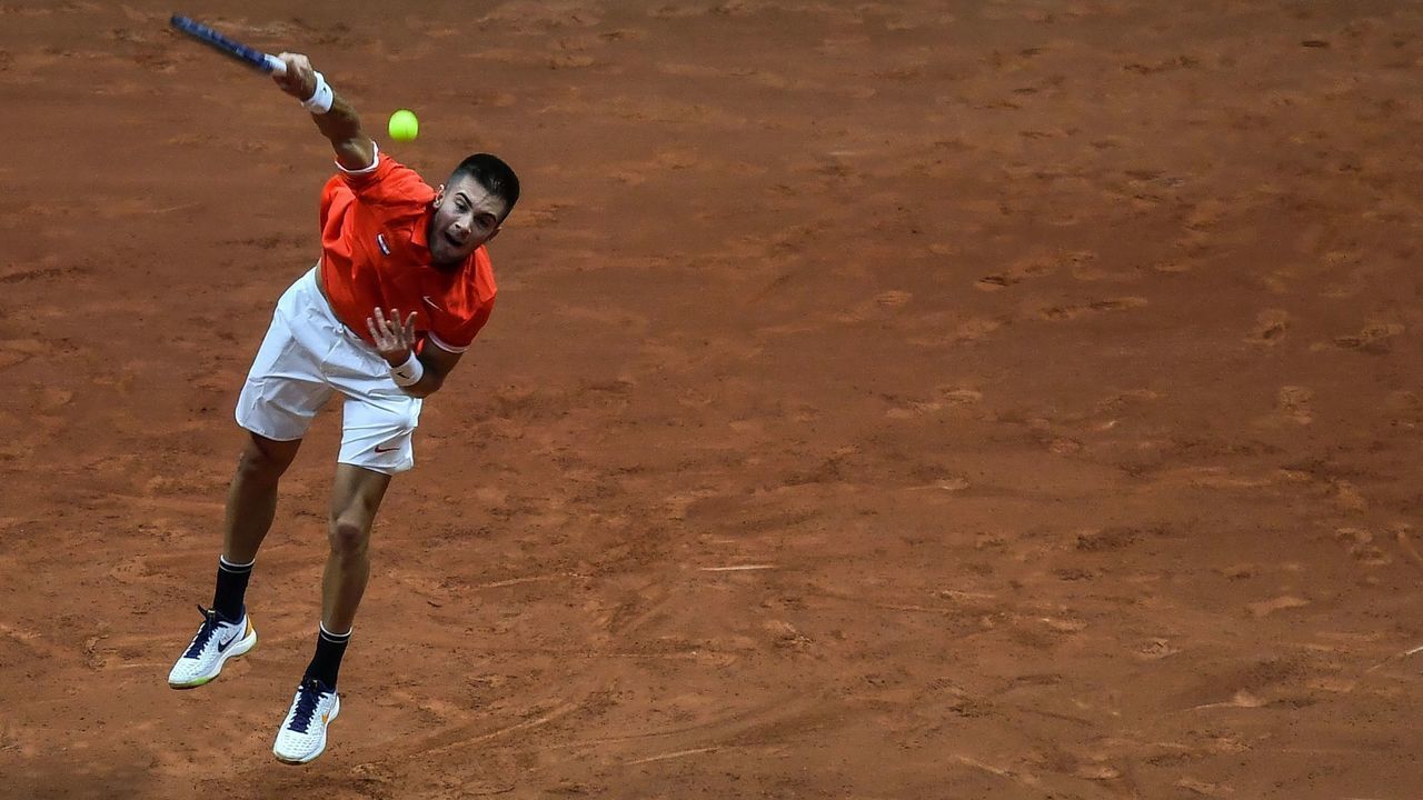 Croatian's Borna Coric serves in his singles rubber against France's Jeremy Chardy during the Davis Cup final tennis match between France and Croatia at The Pierry-Mauroy Stadium in northern France on November 23, 2018.